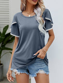 T-shirt à col rond et manches flottantes avec bordure à pompons